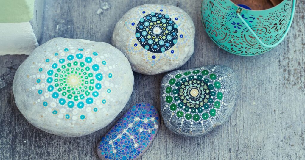 Kamenčići oslikani točkanjem mandala u plavim i tirkiznim tonovima
